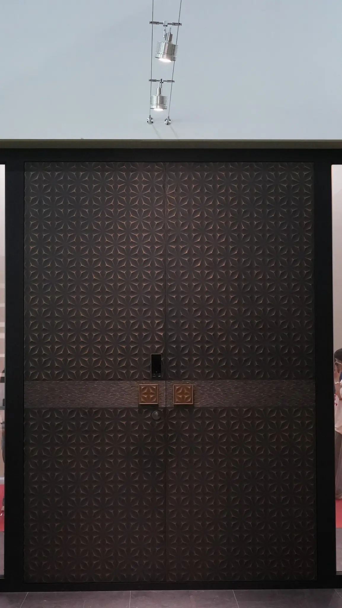 Bronze-toned double entrance with a sculpted relief surface shown at the Yongkang exhibition