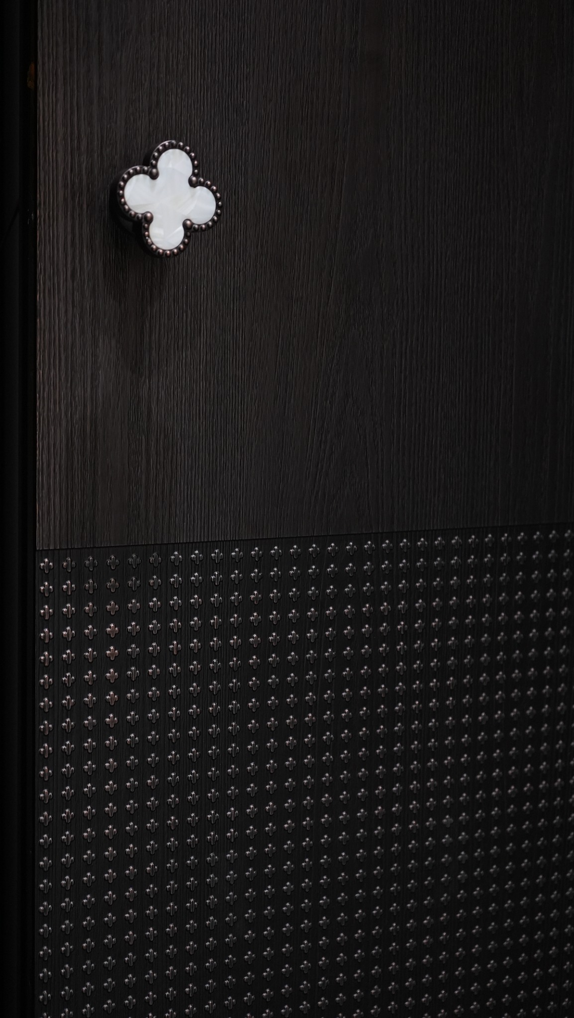 Detail of a dark entrance with a geometric relief surface