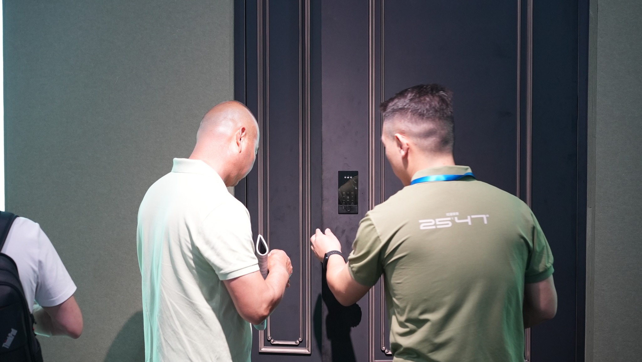 Visitors reviewing an entrance and its integrated access hardware