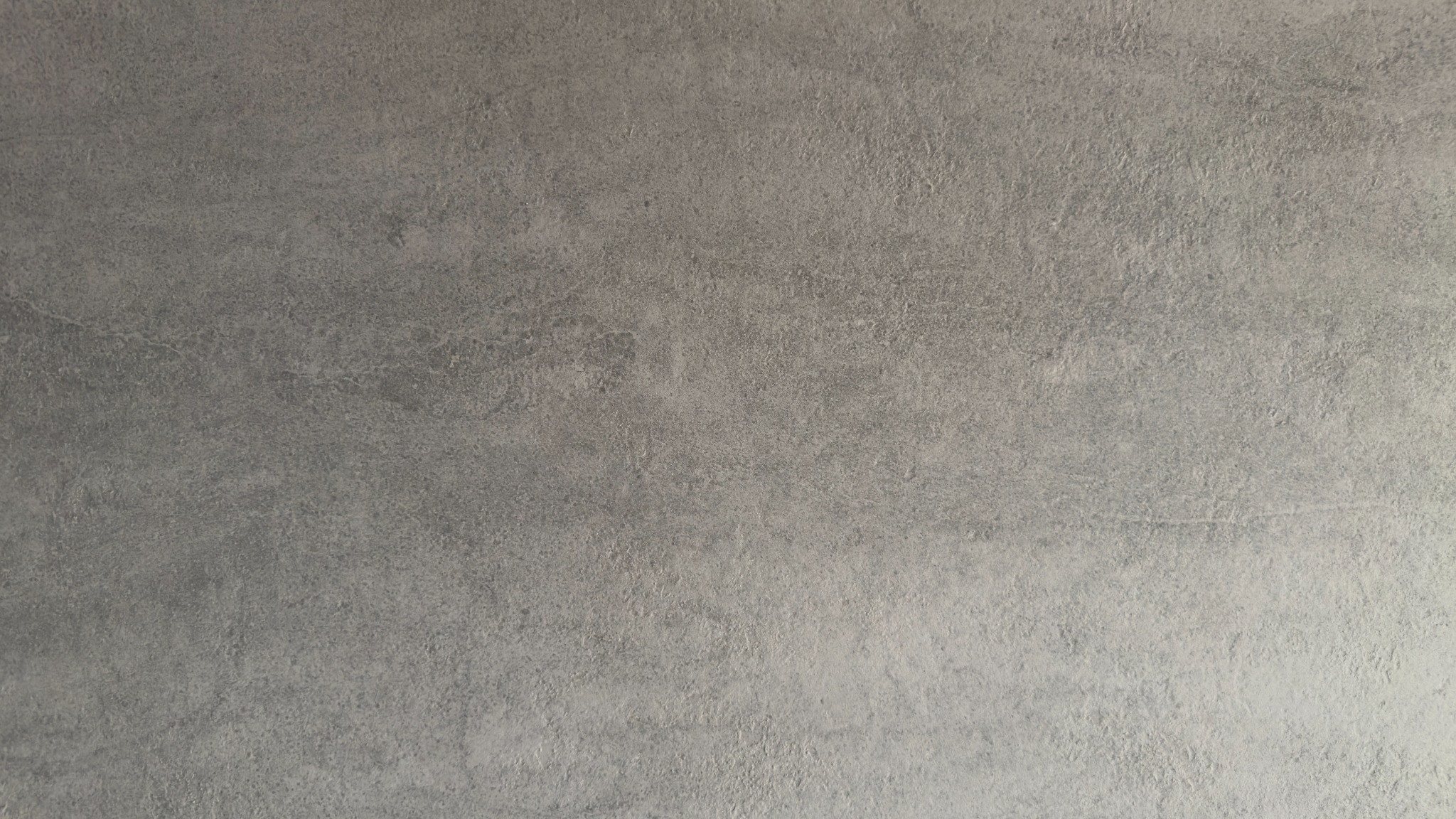 Fine-grained grey entrance surface with soft tonal variation