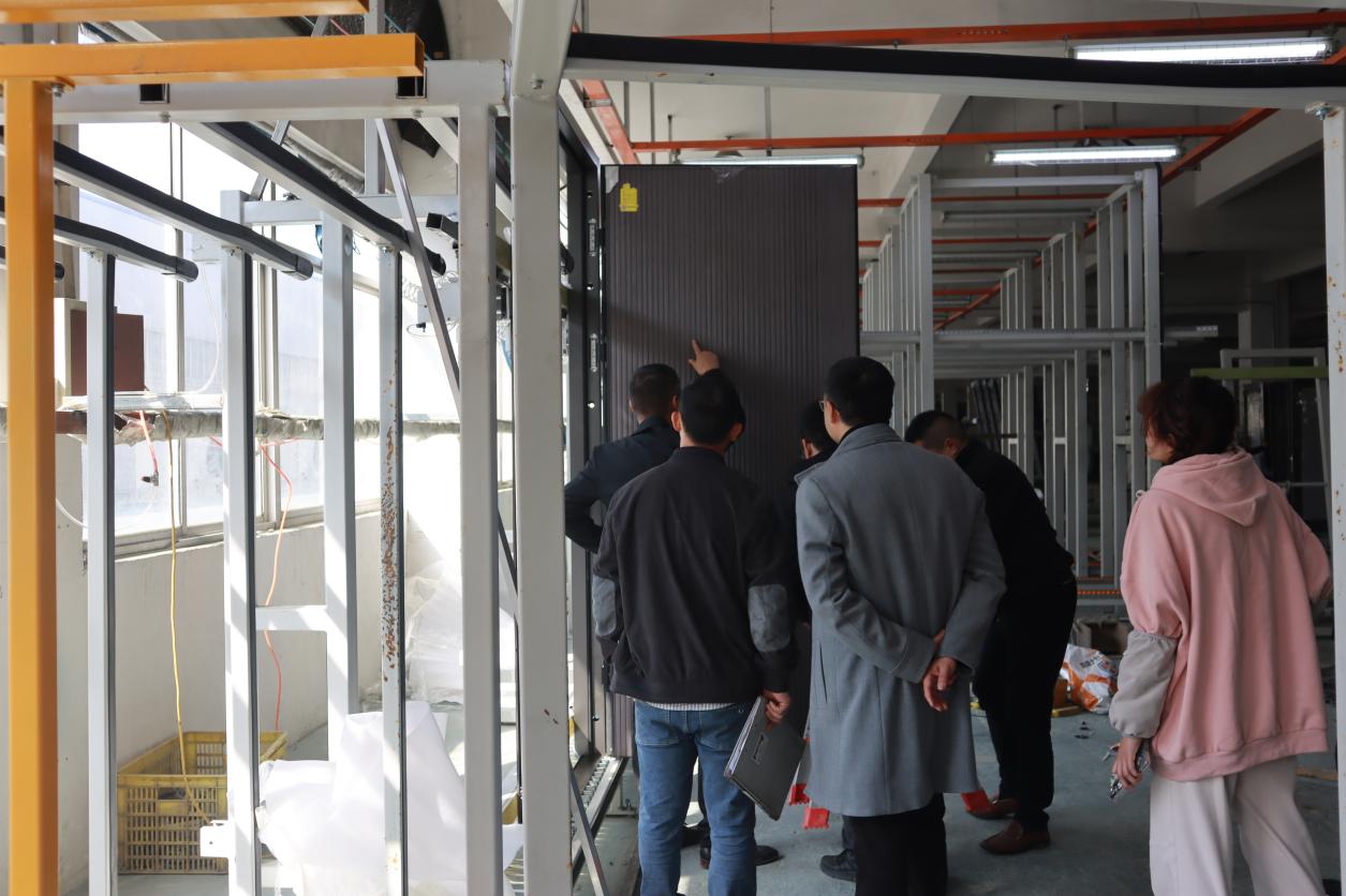 Project representatives reviewing production at the EPIN TOMCIM factory